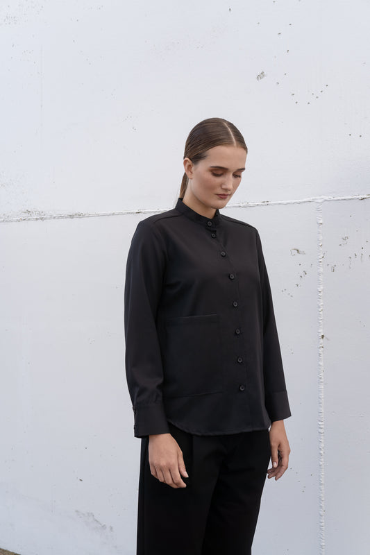 A female model wearing Archetype black wool twill mandarin collar shirt.