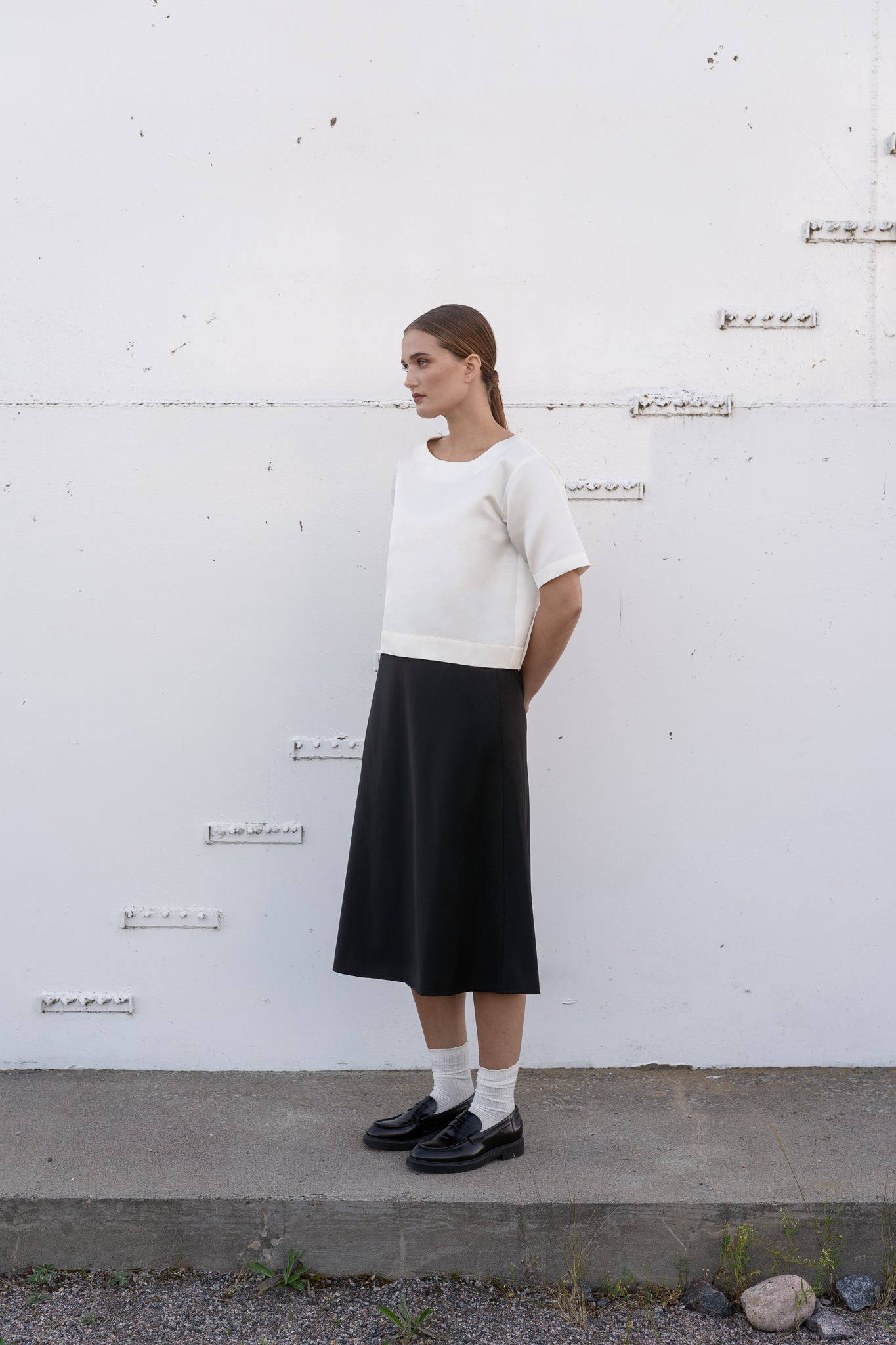 Model wearing ivory silk top and black wool skirt.