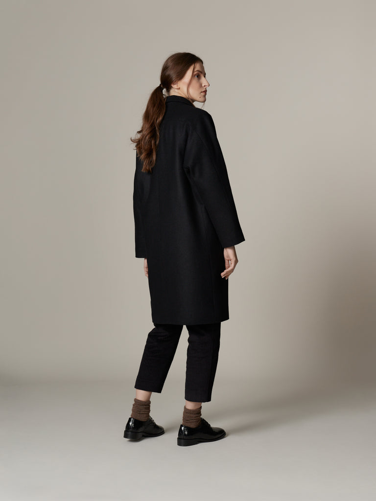 Outfit with minimalist black loden wool overcoat