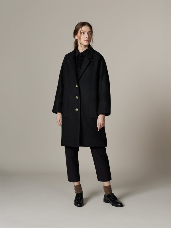 Outfit with minimalist black loden wool overcoat