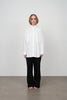 Archetype women's black long straight leg trousers with white cotton oversize shirt. 