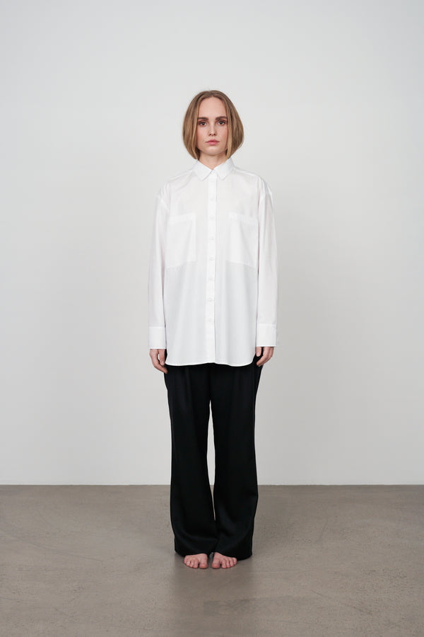 Archetype womens white crispy cotton shirt with oversized minimal style and two patch pockets in the front.